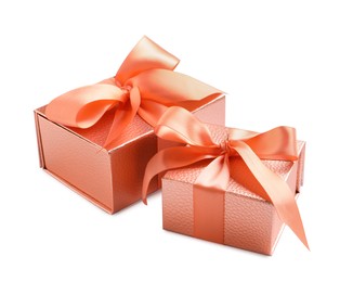 Gift boxes decorated with satin ribbon and bows on white background