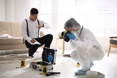 Investigators working at crime scene in living room