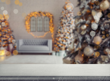 Empty stone surface and blurred view of room decorated for Christmas