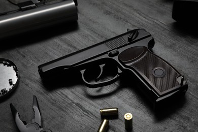 Standard handgun on dark table. Semi-automatic pistol