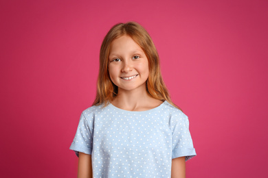 Portrait of preteen girl on pink background