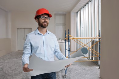 Professional engineer in hard hat with draft indoors