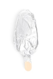 Ice cream bar wrapped in foil on white background, top view