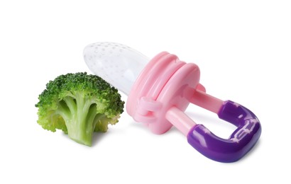Empty nibbler and boiled broccoli on white background. Baby feeder