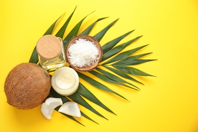 Beautiful composition with coconut oil and nuts on color background