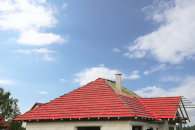 Roof of house under construction against blue sky