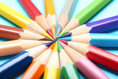 Composition with colorful pencils on light blue background, closeup