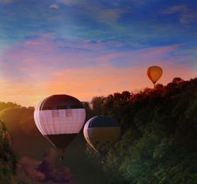 Fantastic dreams. Hot air balloons over forest, beautiful sunset sky