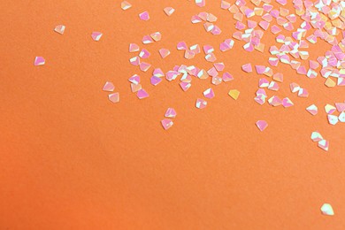 Shiny bright pink glitter on coral background. Space for text