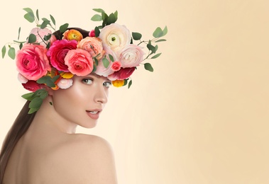 Pretty woman wearing beautiful wreath made of flowers on beige background, space for text