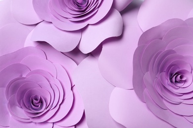 Photo of Beautiful violet flowers made of paper as background, top view
