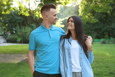 Photo of Affectionate happy young couple walking in park
