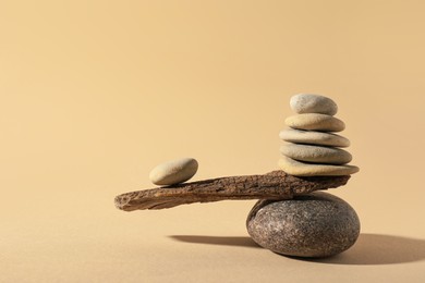 Stones with tree branch on beige background. Harmony and balance concept