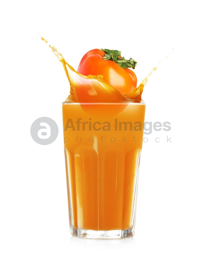 Tasty sweet persimmon falling into glass of juice with splash on white background