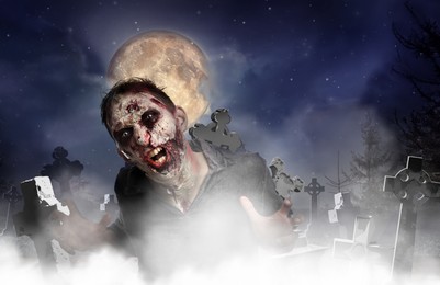 Scary zombie at misty cemetery under full moon. Halloween monster