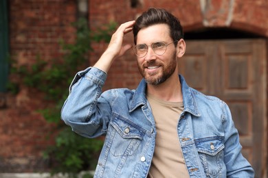 Photo of Handsome bearded man with glasses looking away outdoors