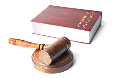 Domestic violence law book and wooden gavel on white background