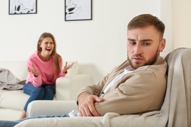 Young couple having argument in living room. Relationship problems