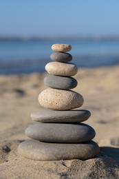 Photo of Stack of stones on beautiful sandy beach
