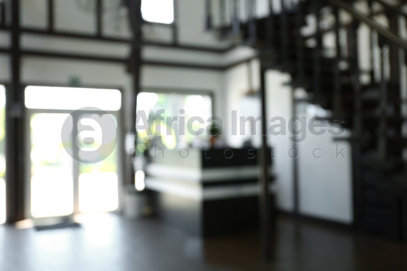 Photo of Blurred view of reception desk and stairs indoors