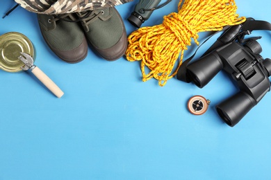 Flat lay composition with camping equipment on color background