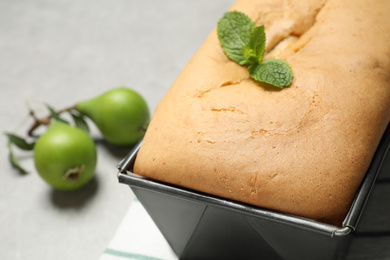 Tasty bread with mint and pears on light grey table, closeup. Homemade cake