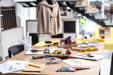 Photo of Fashion designer's workplace in studio. Creating new clothes