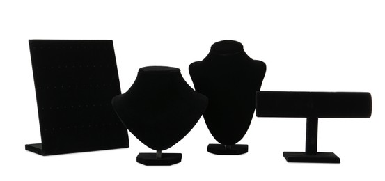 Different empty black velvet jewelry stands on white background