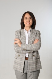Portrait of mature businesswoman on light grey background