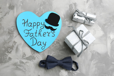 Flat lay composition with greeting card on light grey stone background. Happy Father's Day