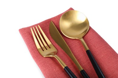 Coral napkin with golden cutlery on white background, closeup