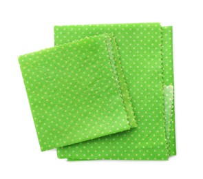 Green reusable beeswax food wraps on white background, top view