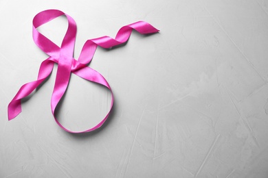 8 March greeting card design with pink ribbon and space for text on light grey background, top view. International Women's day