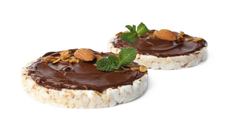 Puffed rice cakes with chocolate spread, nuts and mint isolated on white