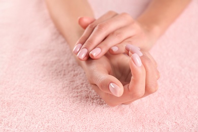 Closeup view of beautiful female hands on towel, space for text. Spa treatment