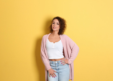 Photo of Beautiful woman in casual outfit on yellow background