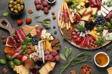 Different tasty appetizers on dark grey table, flat lay