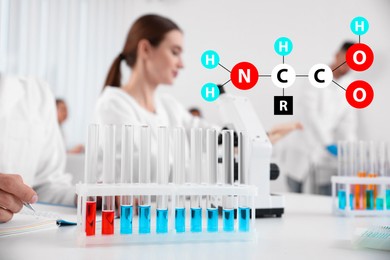 Amino Acids chemical formula, illustration. Rack with test tubes on white table and scientists in laboratory 