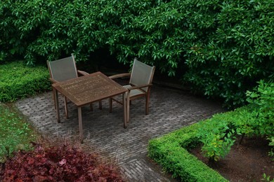 Photo of Cozy yard with patio furniture and green shrubbery