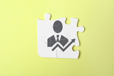 Business development concept. White puzzle pieces on yellow background, top view 