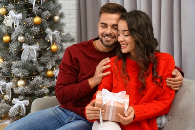 Lovely couple celebrating Christmas together at home