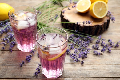 Photo of Fresh delicious lemonade with lavender on wooden table