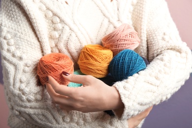 Woman holding clews of knitting threads, closeup