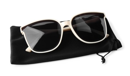 Stylish sunglasses with black cloth bag on white background