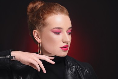 Photo of Portrait of beautiful young woman with makeup posing on color background