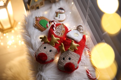 Sweets in soft slippers on windowsill, above view. Saint Nicholas Day tradition