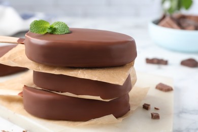 Delicious glazed ice cream bars with mint on board, closeup