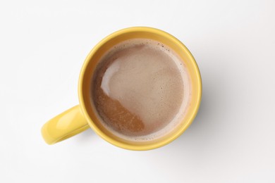 Photo of Yellow mug of freshly brewed hot coffee on white background, top view