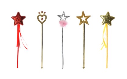 Set with different beautiful magic wands on white background