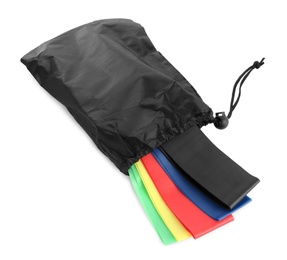 Black bag with colorful elastic resistance bands isolated on white. Fitness equipment